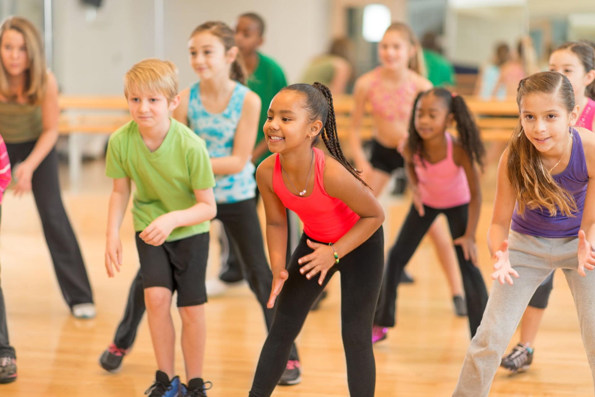 Kids smiling and dancing in a Latin dance class